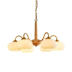 On a plain white studio background, this Clérachic chandelier's six cream shades are shown fully lit.