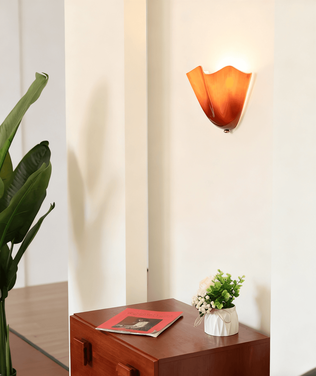 Petalia wall sconce mounted in a cozy reading corner