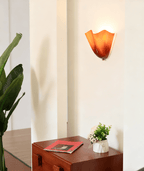 Petalia wall sconce mounted in a cozy reading corner