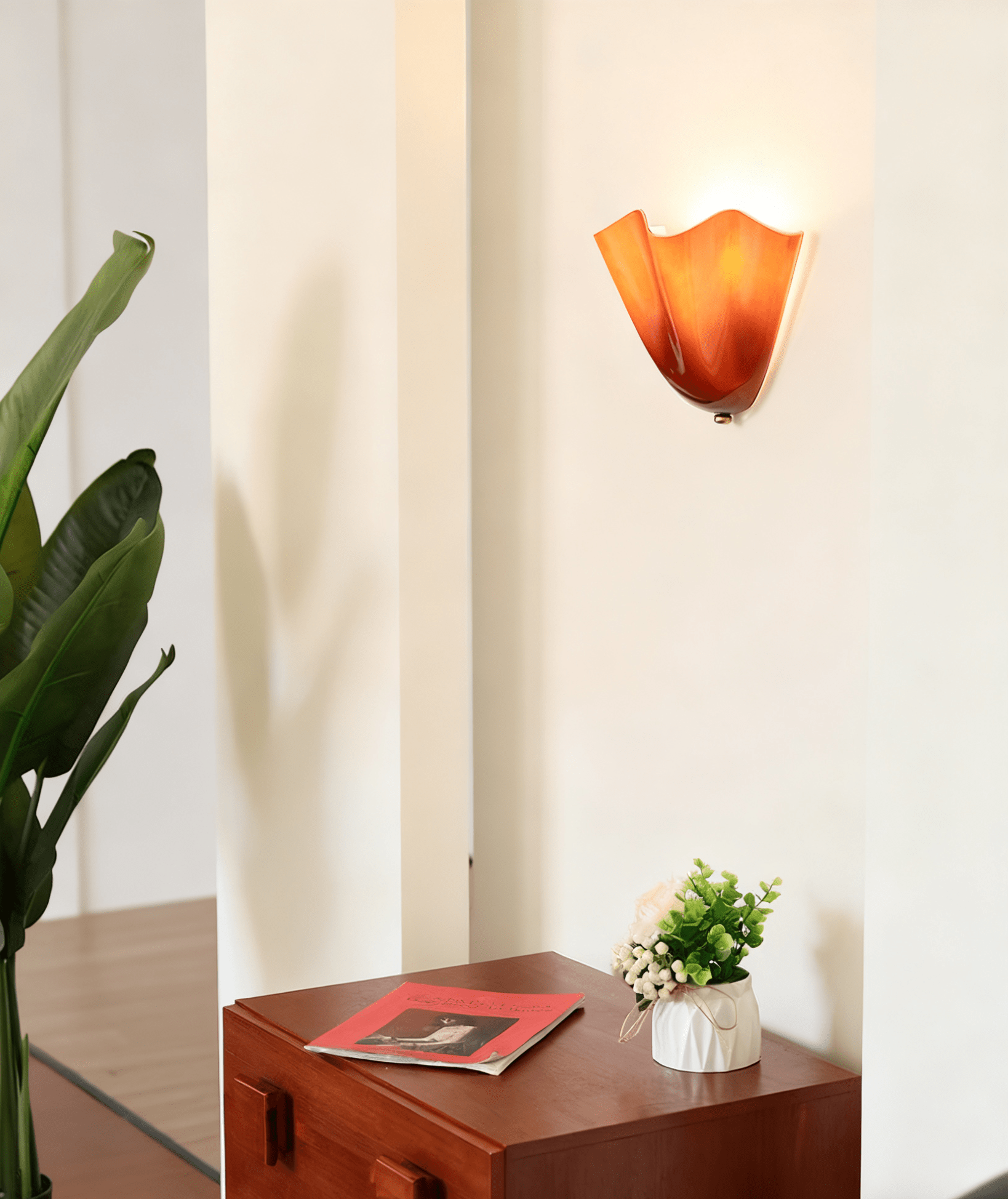 Petalia wall sconce mounted in a cozy reading corner