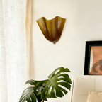 Petalia wall sconce petal silhouette shown unlit on the wall