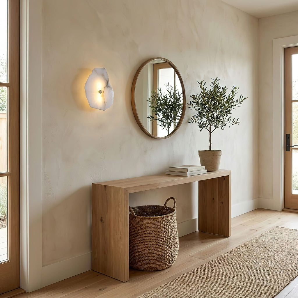Alabaster wall lamp with gold finish glowing in interior