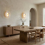 Alabaster wall lamp glowing with warm mineral light