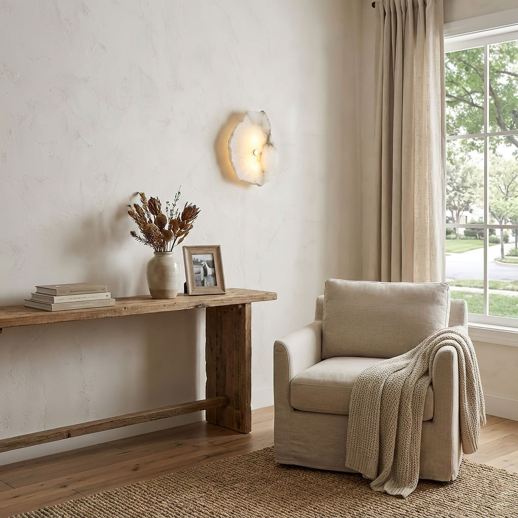 Alabaster wall sconce with gold finish on neutral wall