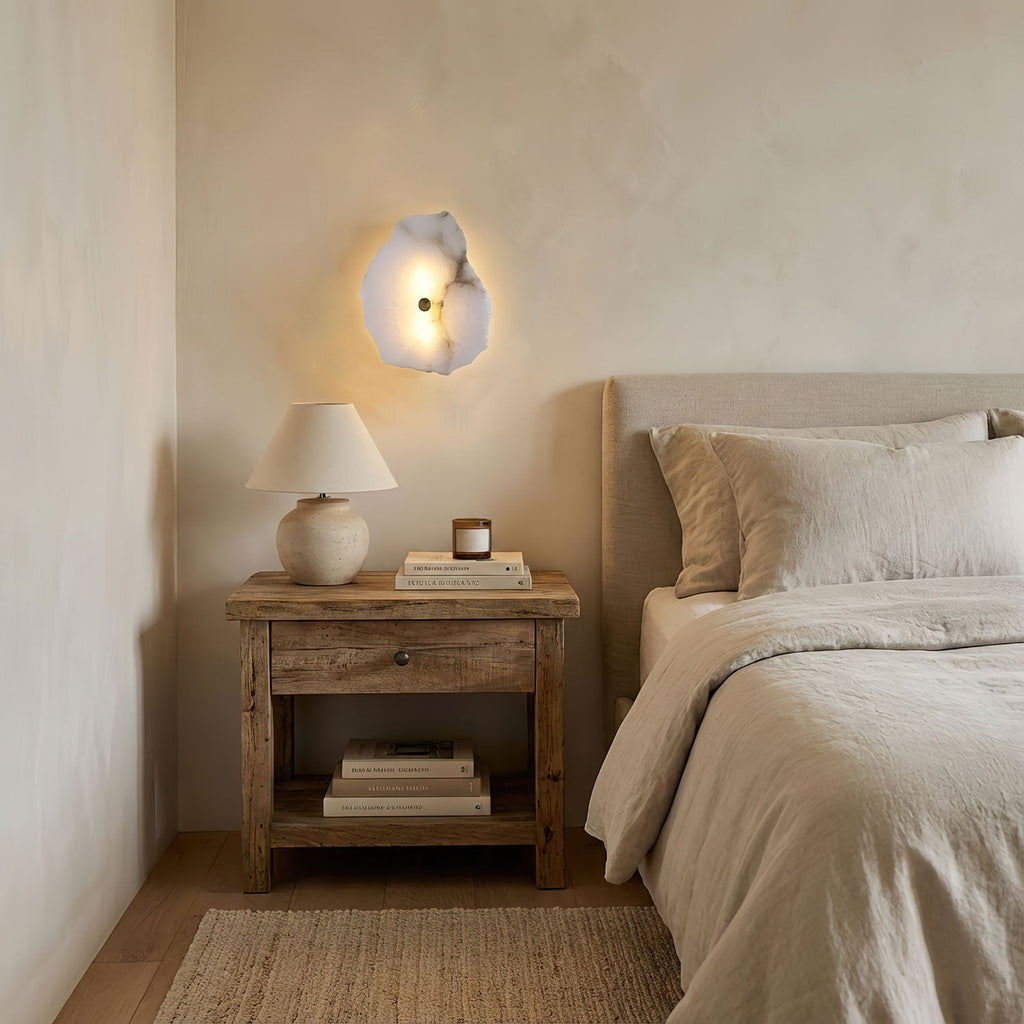Alabaster wall lamp casting a subdued warm glow