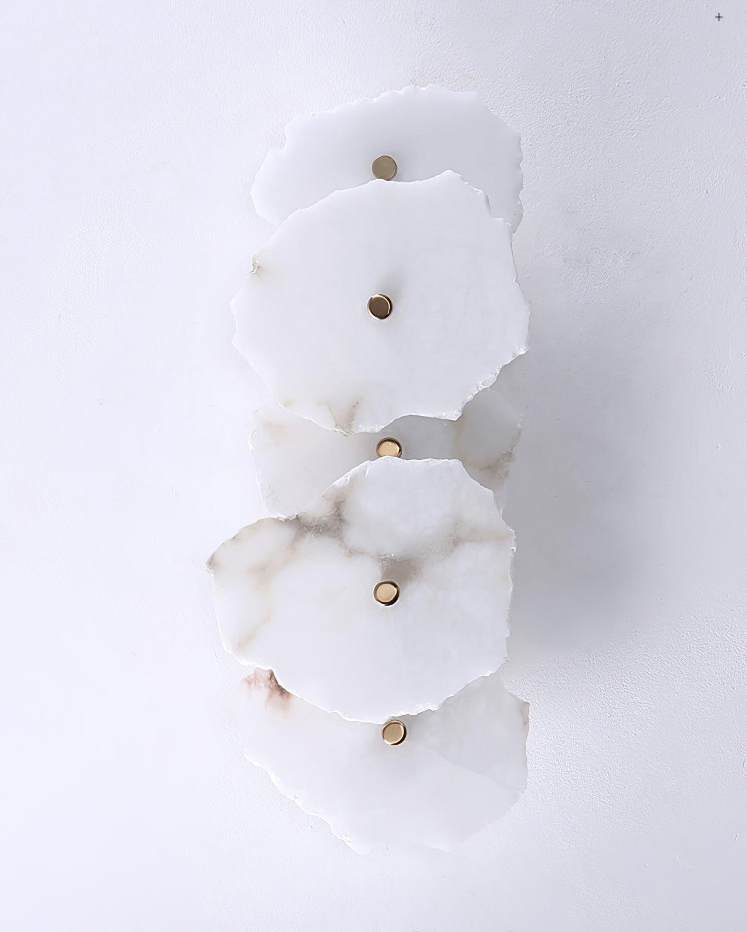Five-head Alaeila alabaster wall light switched off on a white wall, brass studs in view.