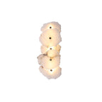 Five-head alabaster wall lamp in the vertical arrangement, warm light washing out from behind each slab.