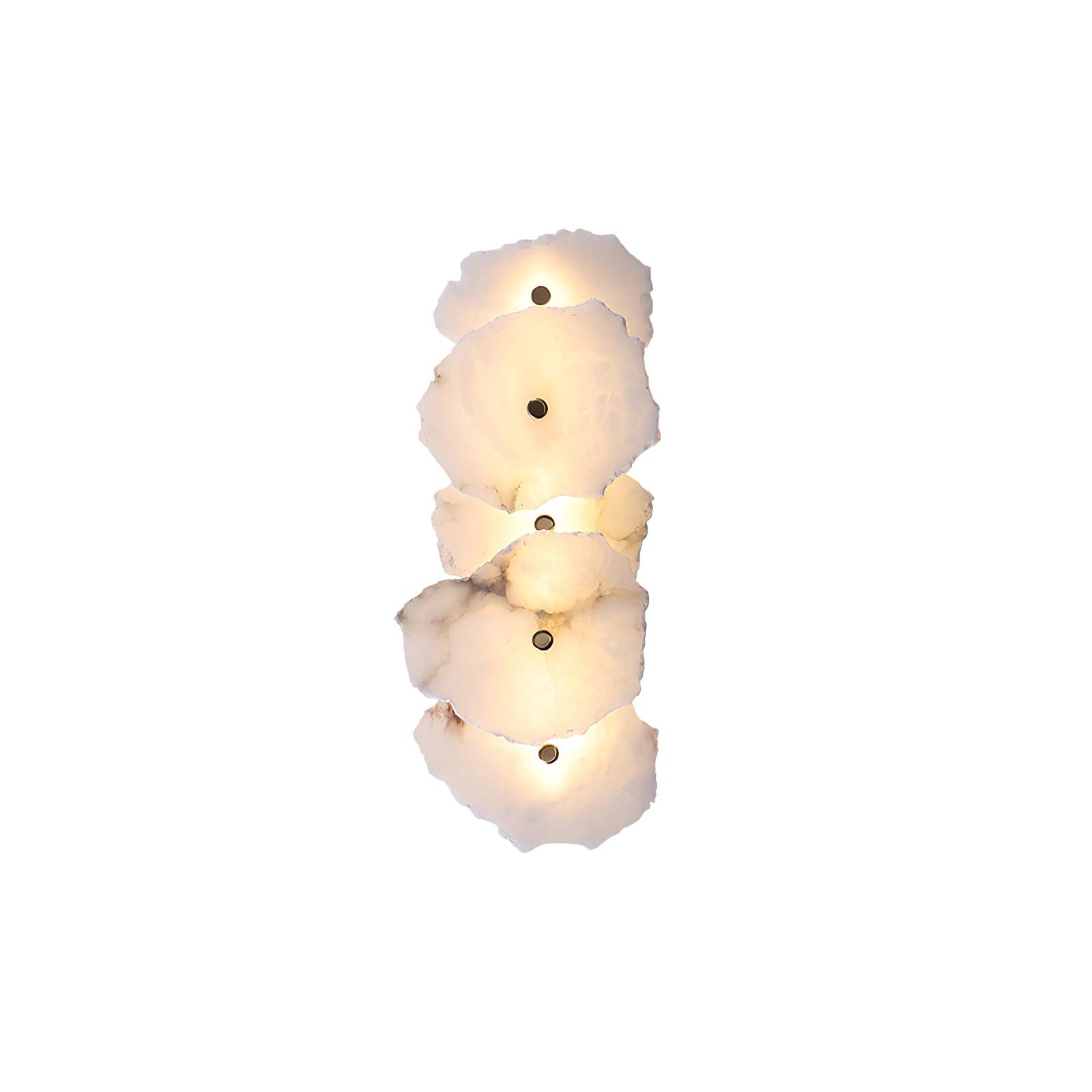 Five-head alabaster wall lamp in the vertical arrangement, warm light washing out from behind each slab.