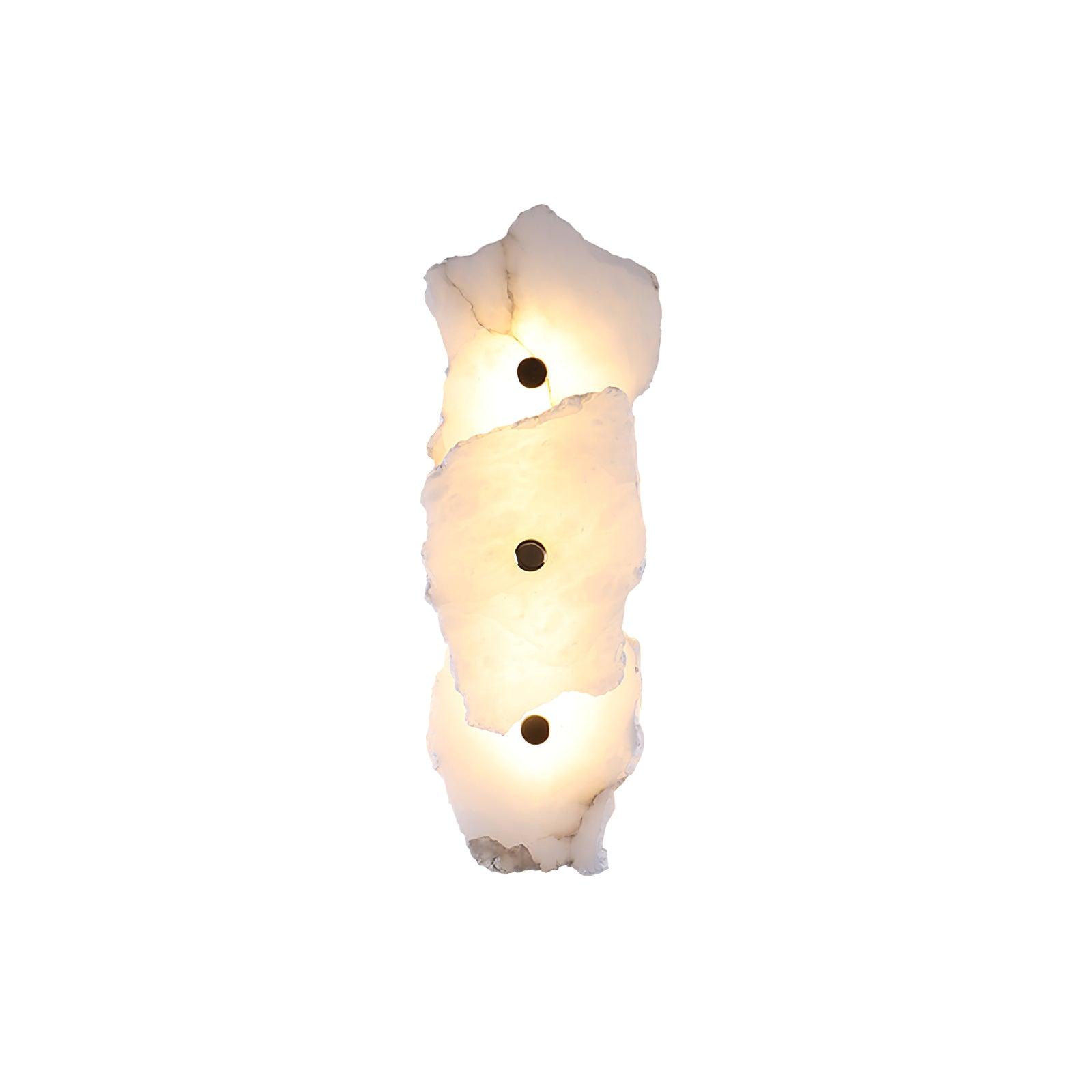 Three-head alabaster wall lamp stacked vertically, each stone slab lit warm and pinned by a brass stud.