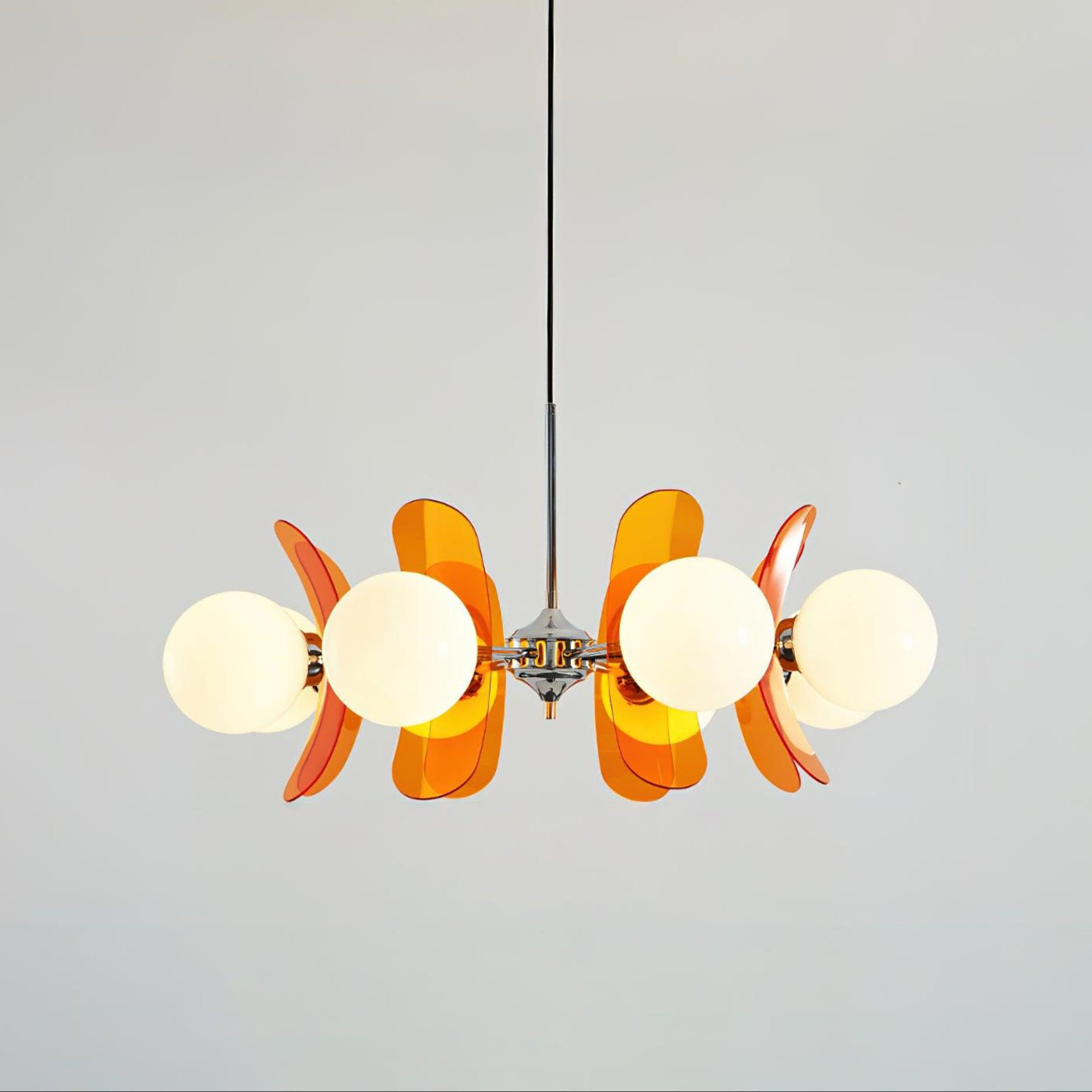 Sputnik chandelier glowing with warm light in interior