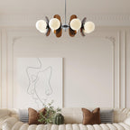 Iron and glass chandelier glowing in a styled interior