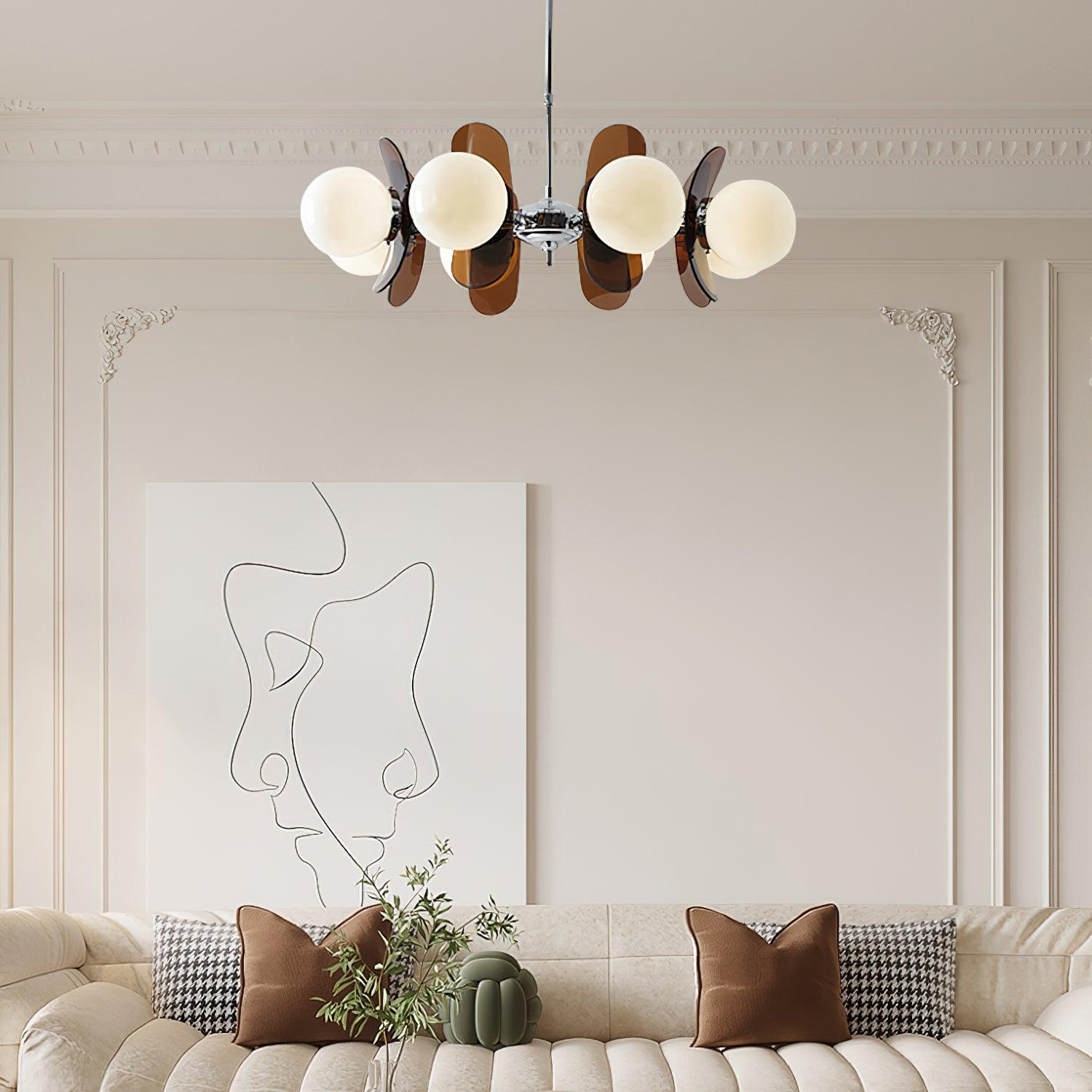 Iron and glass chandelier glowing in a styled interior