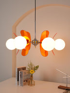 Iron chandelier with multiple glass globes and warm glow