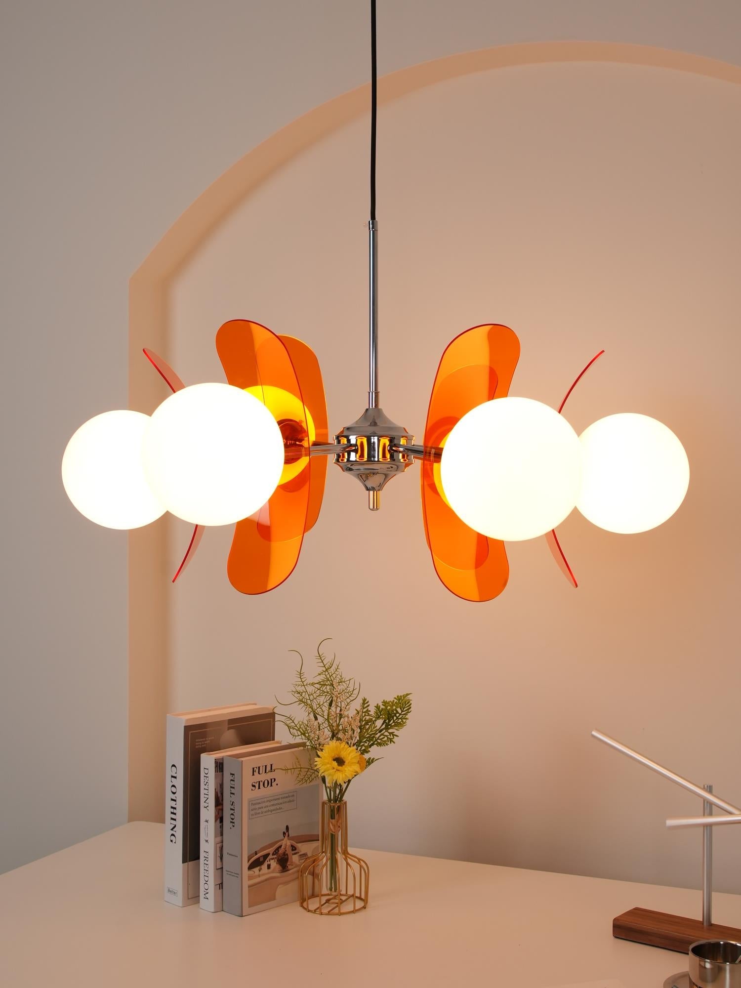 Iron chandelier with multiple glass globes and warm glow
