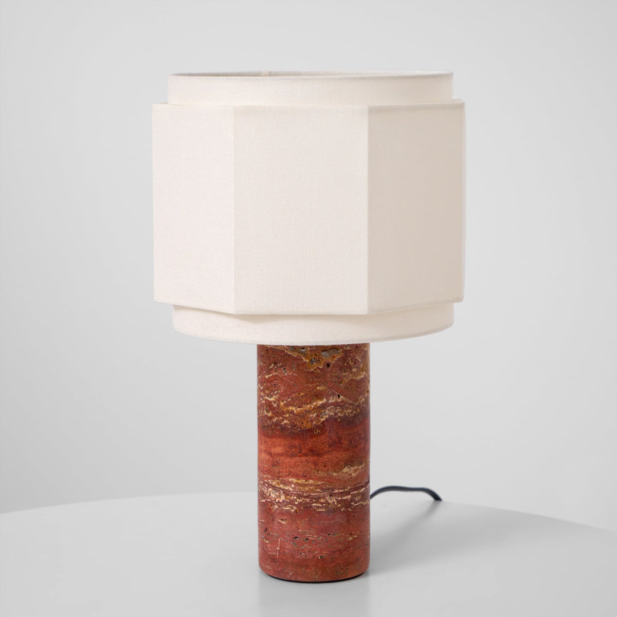 Full view of the hexagonal-shade table lamp from Clérachic against a plain grey background, base to shade.