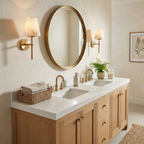 A pair of these Clérachic wall lights in brushed brass flank a round mirror above an oak double vanity.