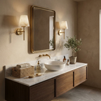 Framing a brass-edged mirror over a vessel sink, two brushed brass Clérachic wall lights light a walnut vanity.