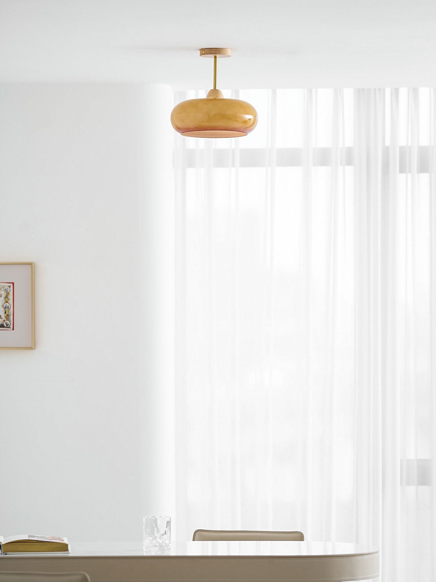 Plafonnier ceiling light orange finish glowing in a styled interior