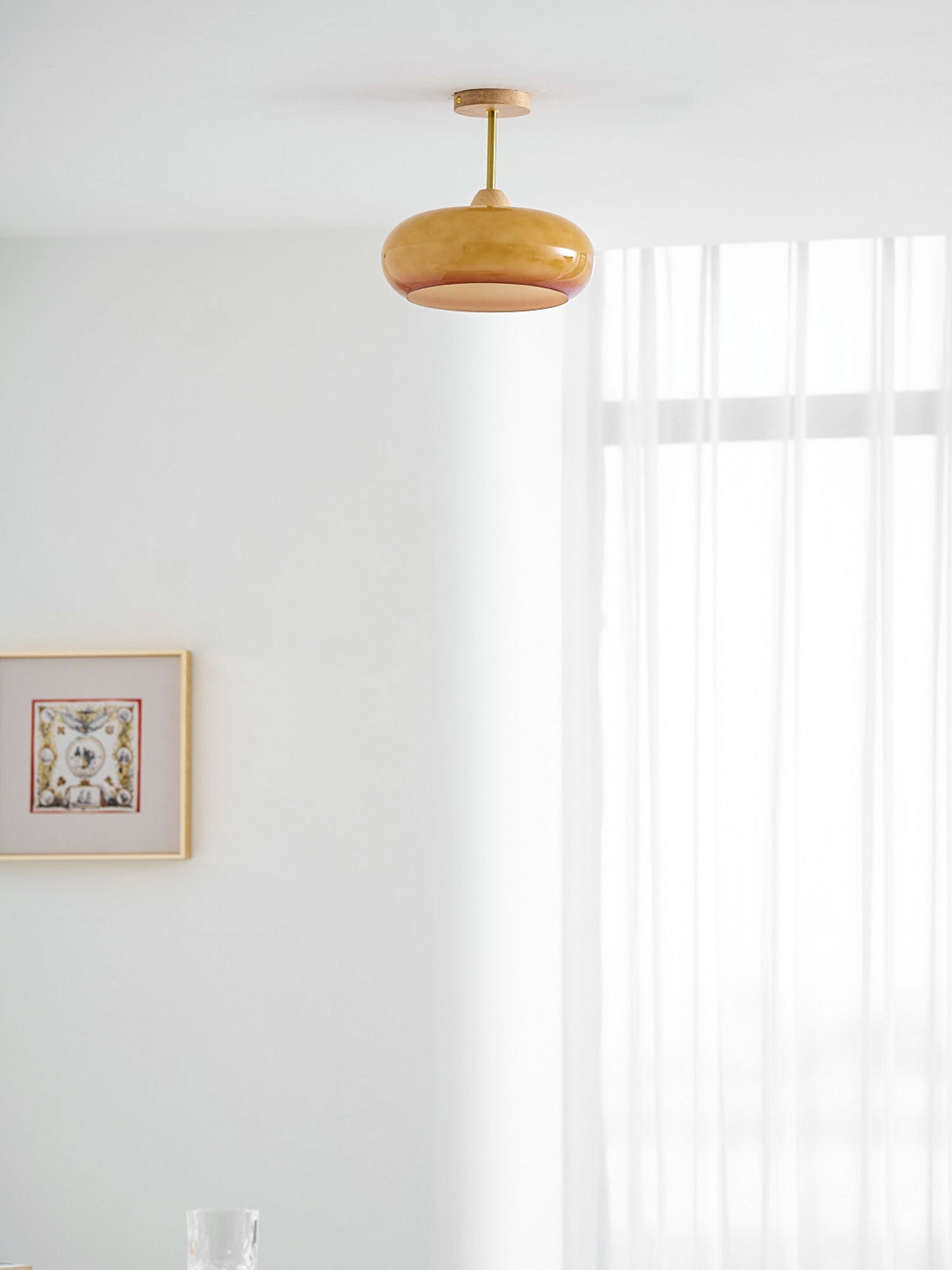 Plafonnier ceiling light orange disc seen from below with warm light