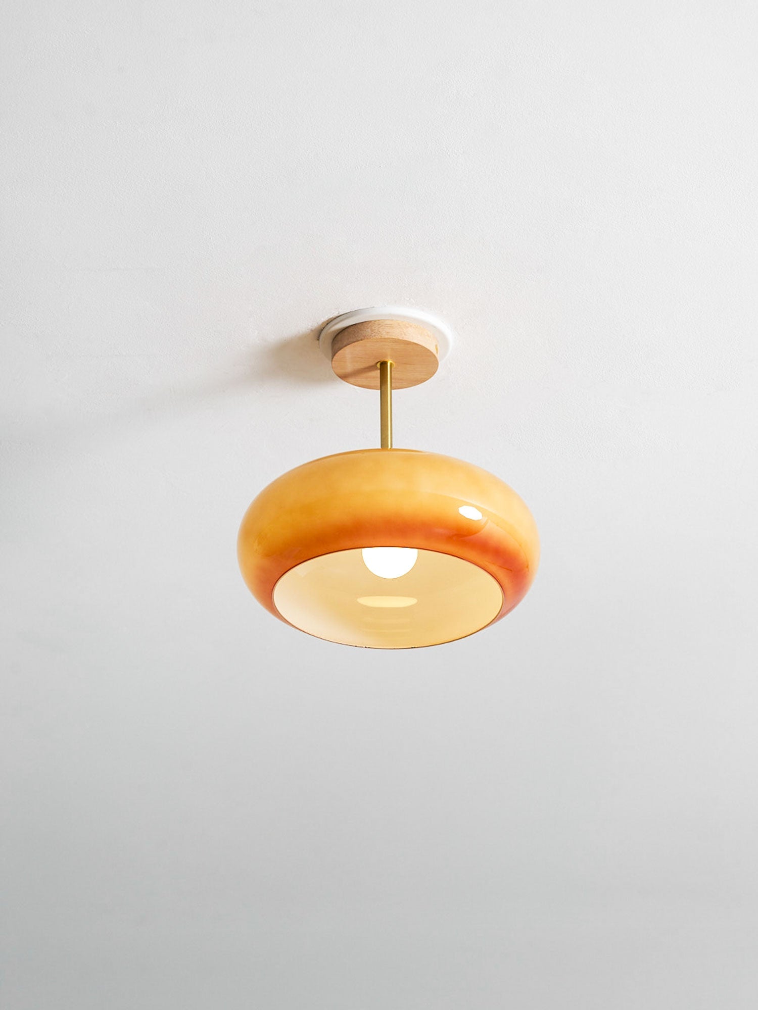 Plafonnier ceiling light in orange finish mounted on the ceiling