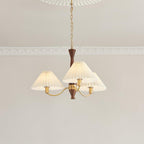 Looking up at the three-head version of this Clérachic chandelier, its pleated shades clustered close beneath the ceiling.