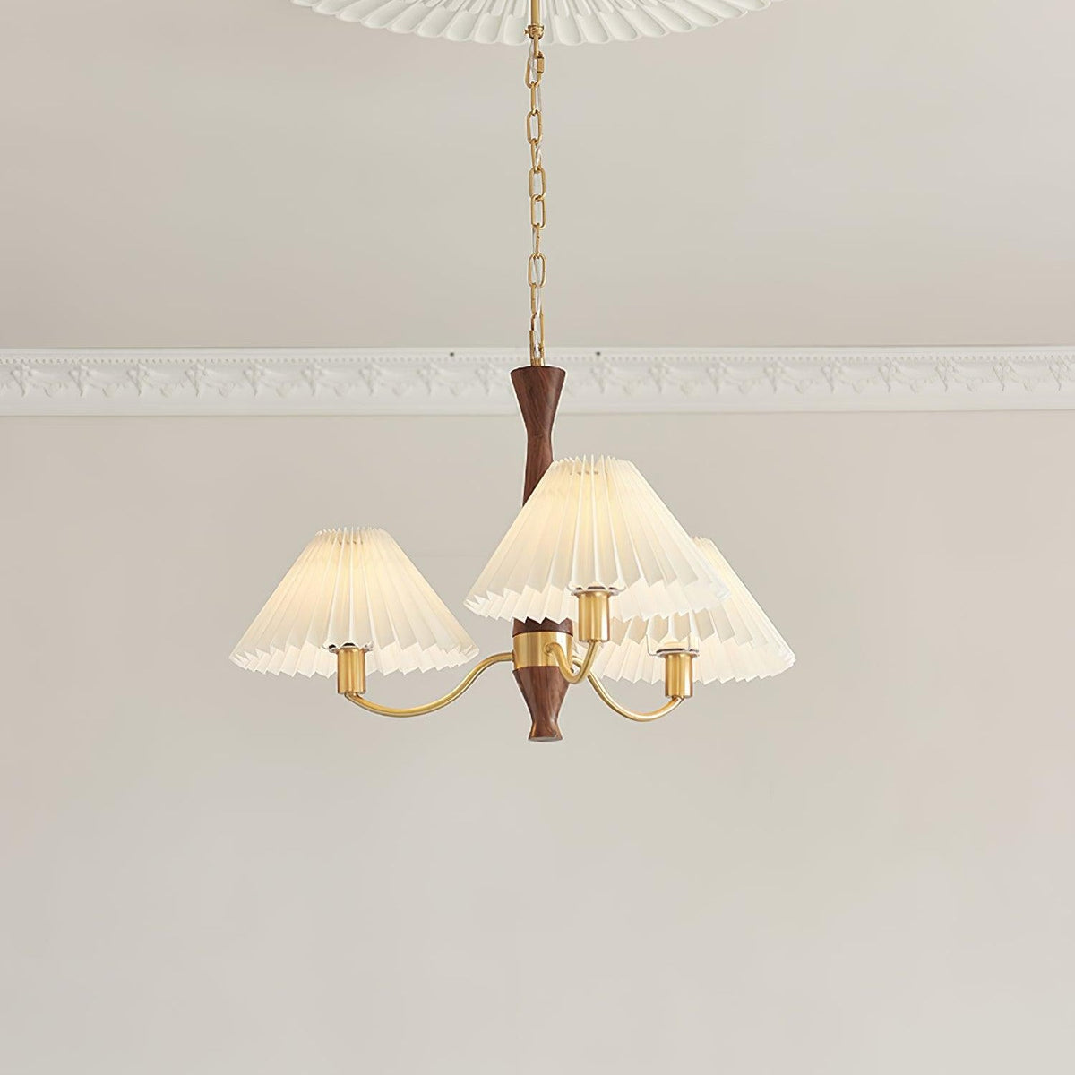 Looking up at the three-head version of this Clérachic chandelier, its pleated shades clustered close beneath the ceiling.