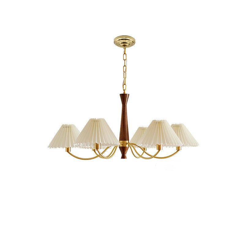 Brass arms and pleated shades on this Clérachic chandelier are shown in full against a plain white backdrop.
