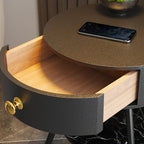 A close-up of the bronze-toned Clérachic tabletop shows a phone resting beside the open, wood-lined drawer.