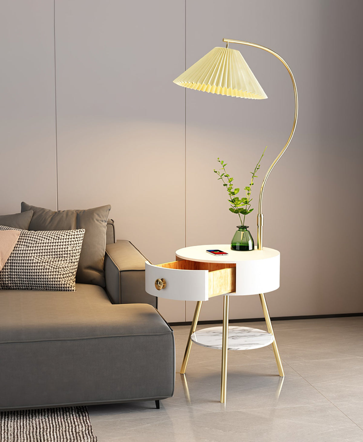 Beside the same grey sofa, the Clérachic floor lamp's pleated shade glows a warm cream over the white table.