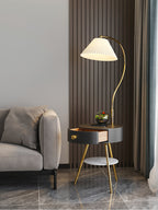 A wider view of the black-and-brass Clérachic lamp shows the terrarium, open drawer and marble floor beyond.