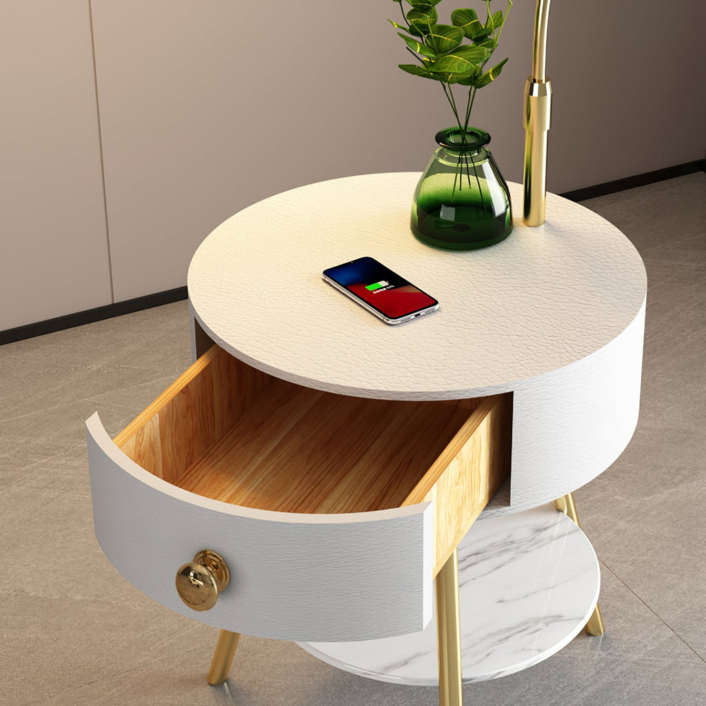 This overhead close-up shows the white Clérachic tabletop's texture, a charging phone and the drawer's brass pull.
