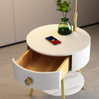 This overhead close-up shows the white Clérachic tabletop's texture, a charging phone and the drawer's brass pull.