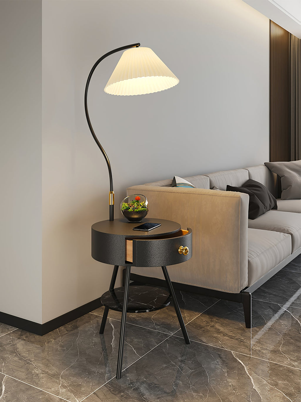In black, the Clérachic lamp holds a terrarium on its tabletop beside a tan sofa and wood-slat wall.