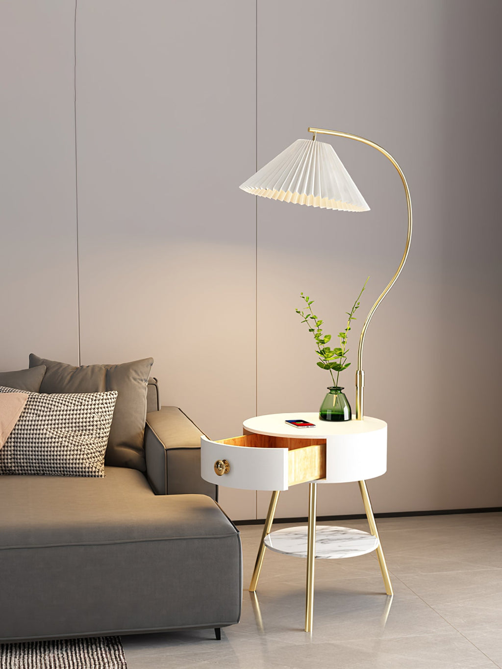 The white Clérachic floor lamp stands by the grey sofa, its drawer open beneath a vase of greenery.
