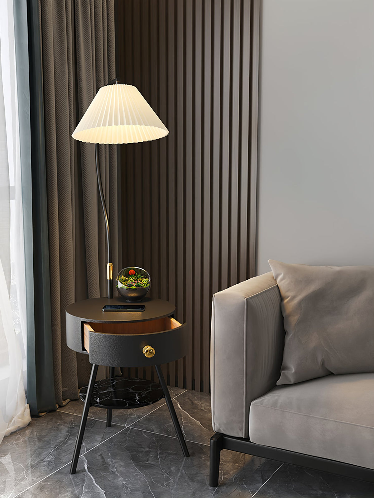 Shown full-height against a curtain and slatted wall, the black Clérachic lamp's marble shelf sits near the sofa edge.