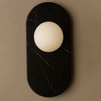 Another close view of the black marble finish on this Clérachic wall sconce, cropped tighter to show the stone's fine veining.
