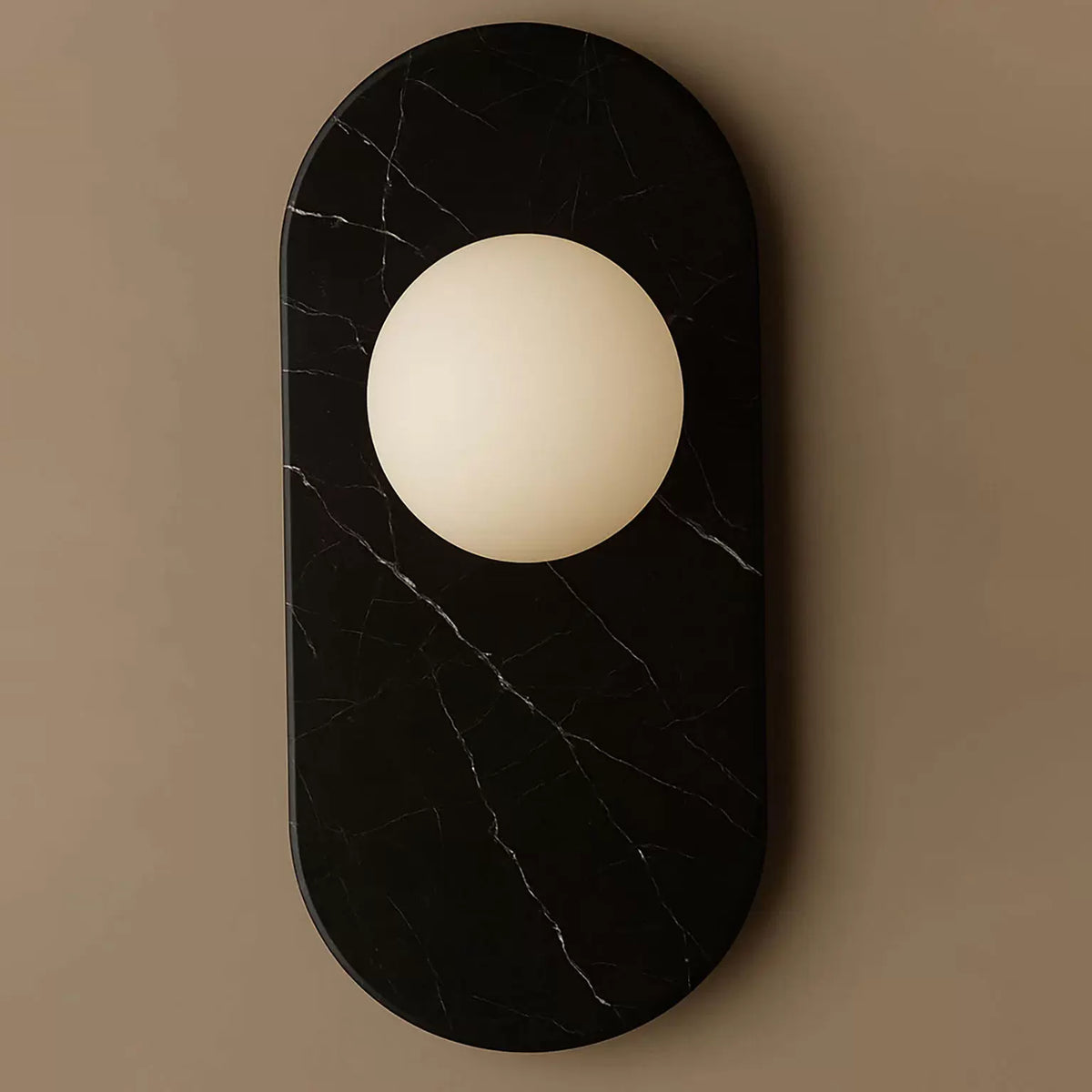 Another close view of the black marble finish on this Clérachic wall sconce, cropped tighter to show the stone's fine veining.