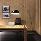 Verse arc floor lamp standing in a minimalist corner