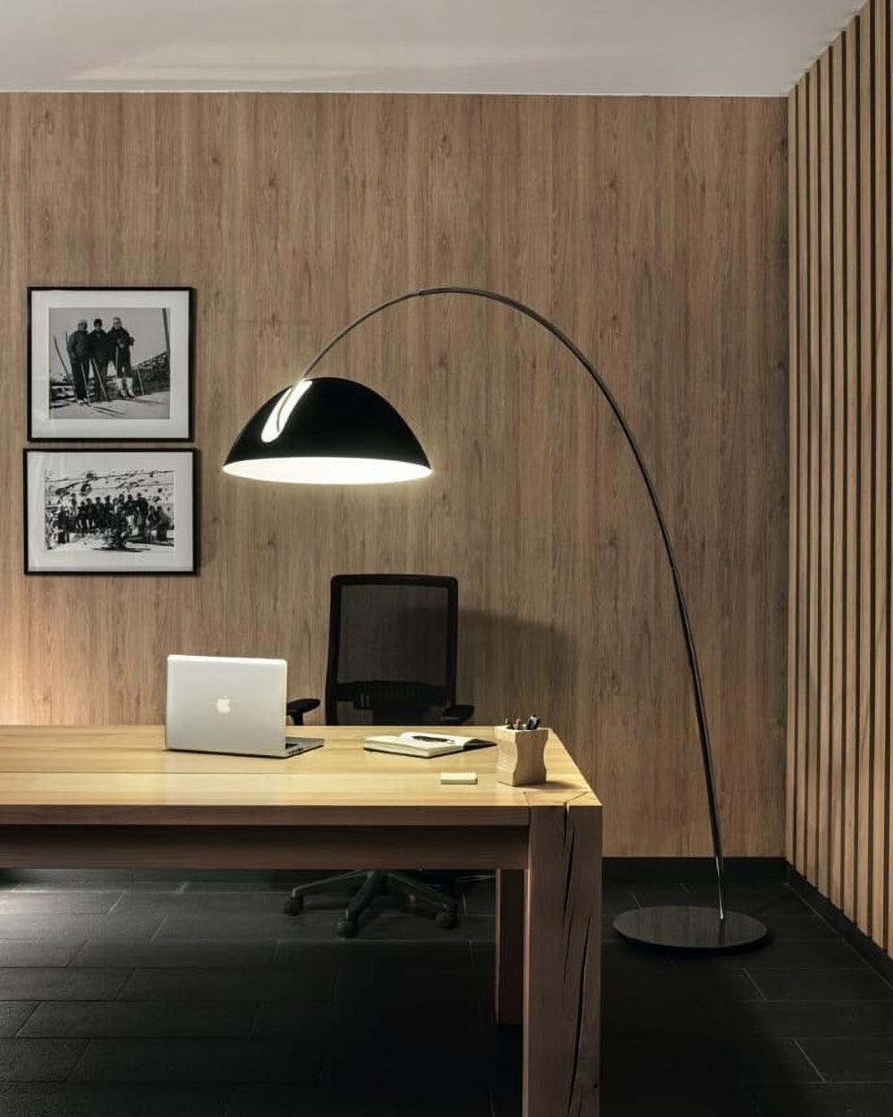 Verse arc floor lamp standing in an open-plan living area