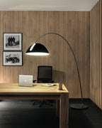 Verse arc floor lamp standing in an open-plan living area