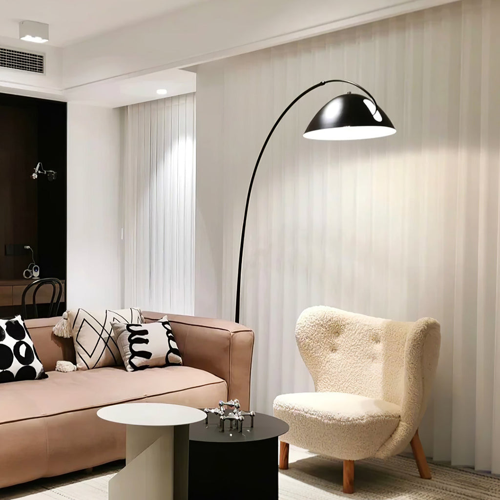 Verse arc floor lamp arcing beside a reading chair