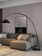 Verse arc floor lamp arcing over a coffee table