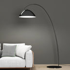 Verse arc floor lamp arcing over a sofa with warm light
