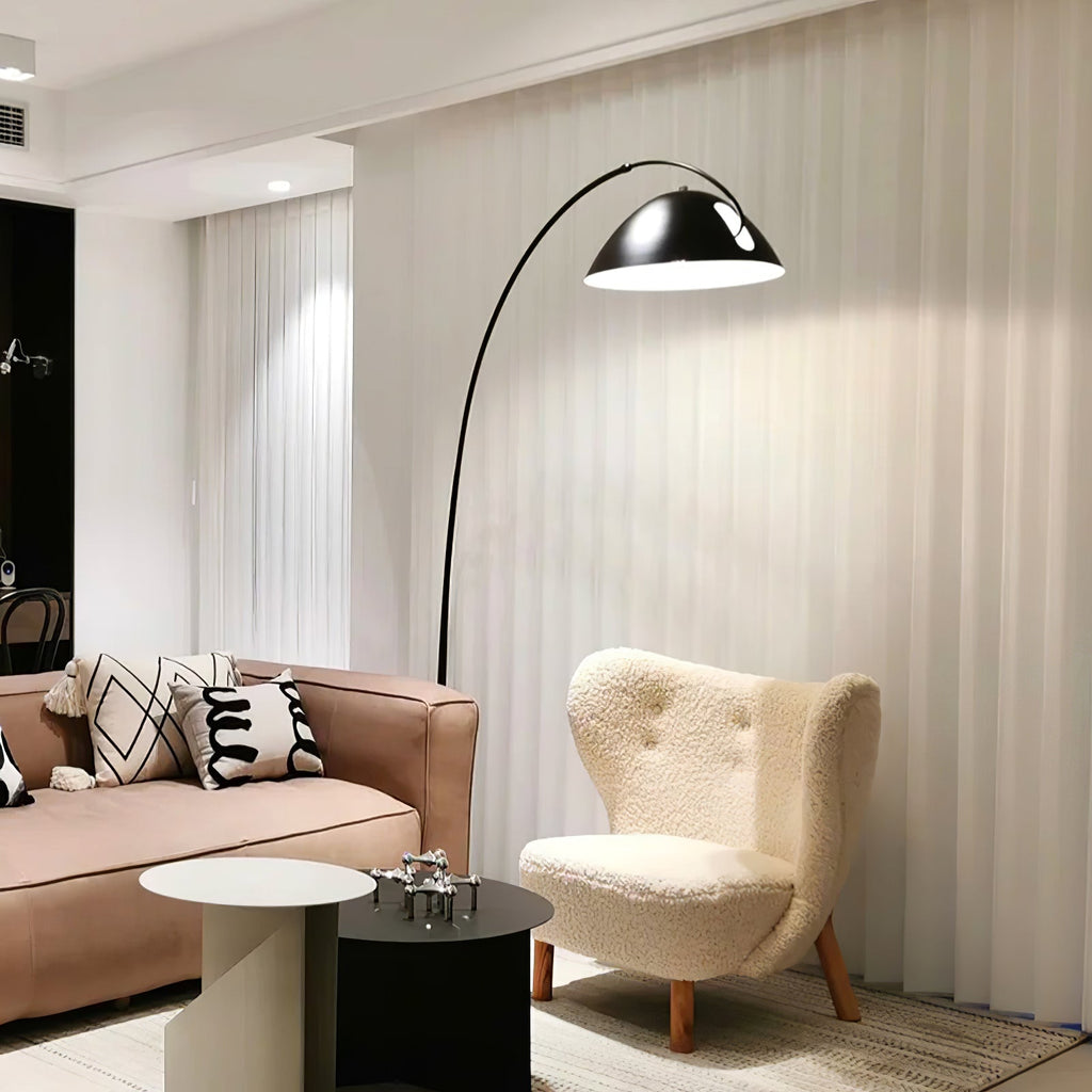 Verse arc floor lamp standing beside soft furnishings