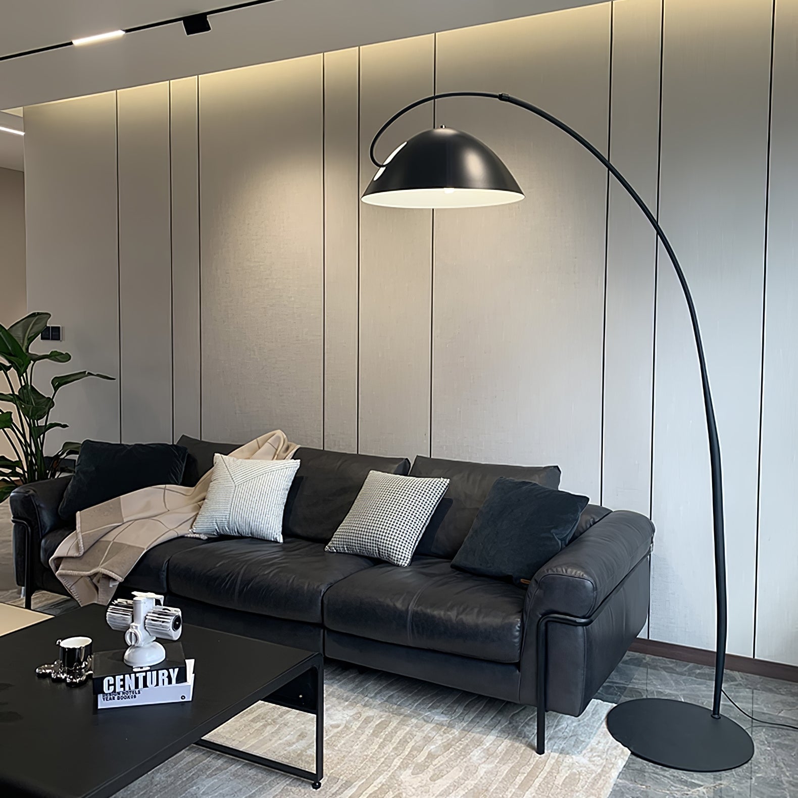 Verse arc floor lamp arcing across a modern living space