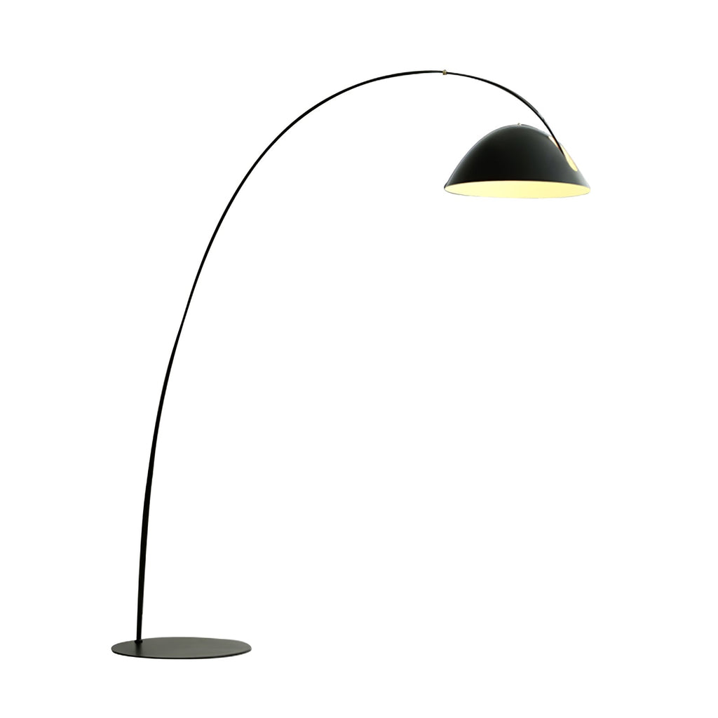 Verse arc floor lamp lit beside a sofa in a cozy interior