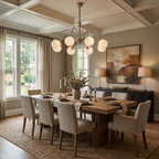 A long wood table and linen-covered chairs fill a coffered-ceiling dining room lit by this brass Clérachic chandelier.