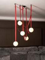 Belt pendant light hanging in a styled living room