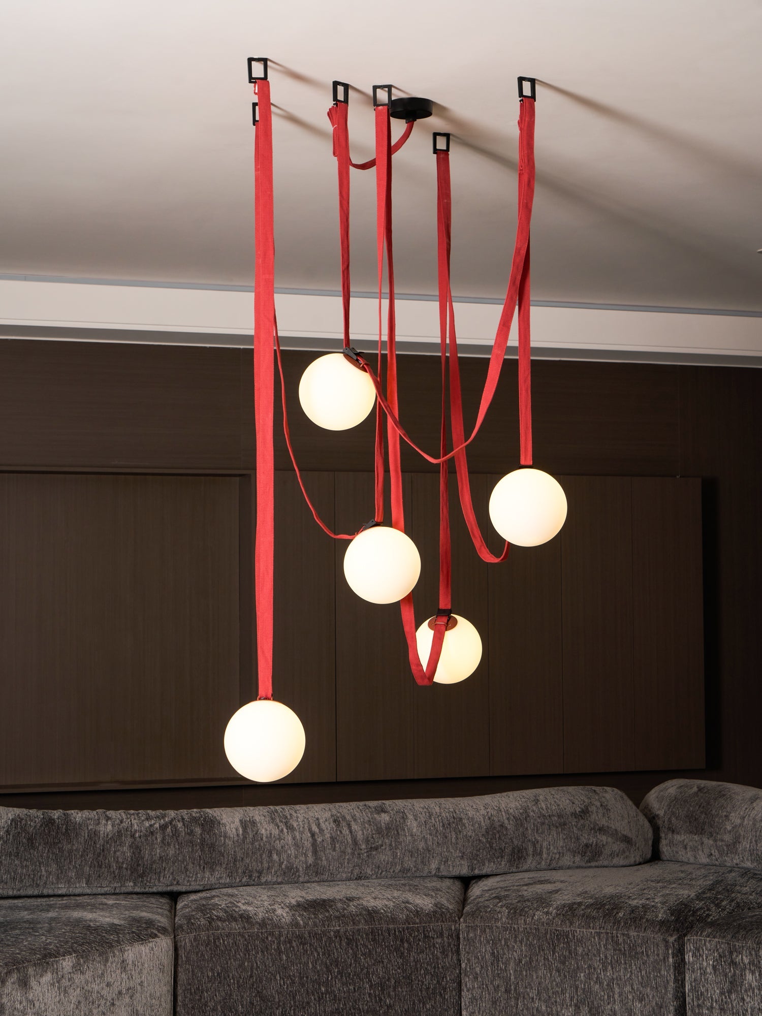 Belt pendant light hanging in a styled living room