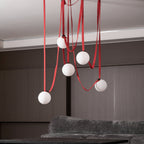 Belt pendant light globes lit against a dark ceiling